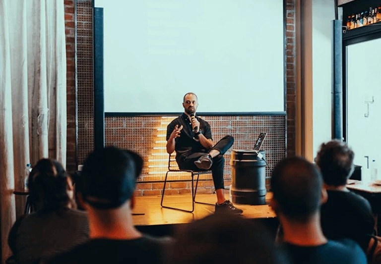 A speaker presenting to a seated audience